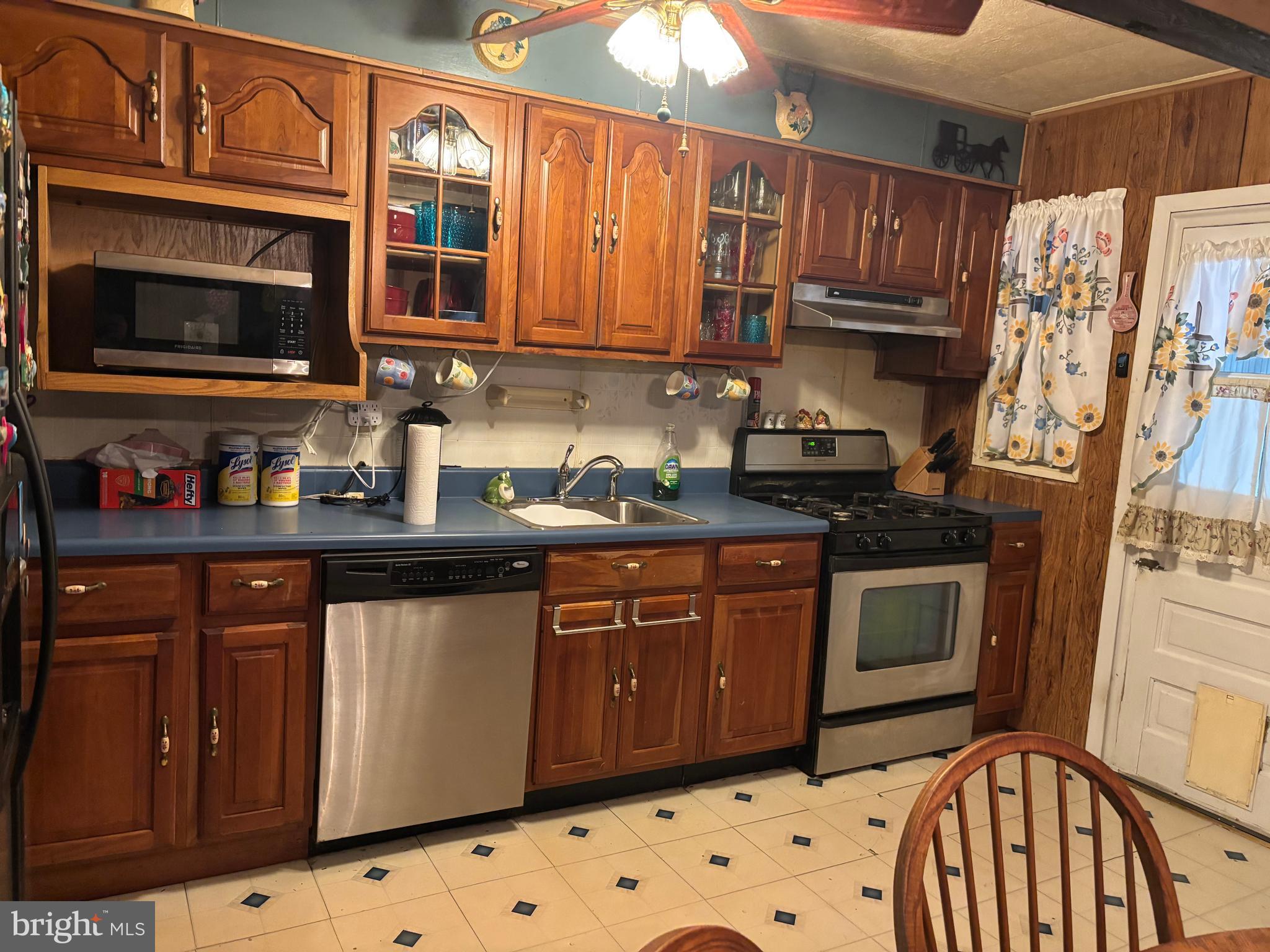 7552 Rabon Avenue Baltimore, MD 21222 - Photo 10 of 39 a kitchen with stainless steel appliances granite countertop a stove a sink and a microwave