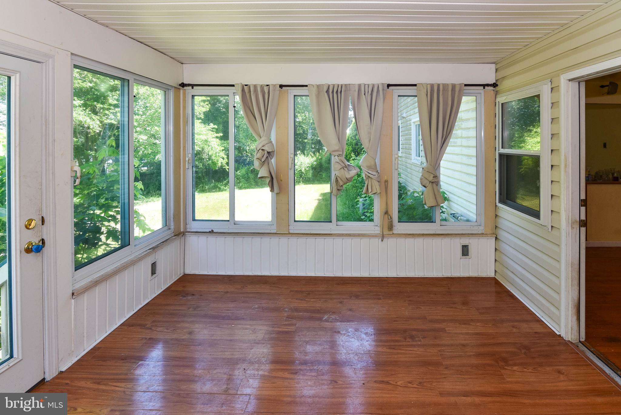 1204 Dicus Mill Road Millersville, MD 21108 - Photo 12 of 63 a view of an empty room with wooden floor and a window