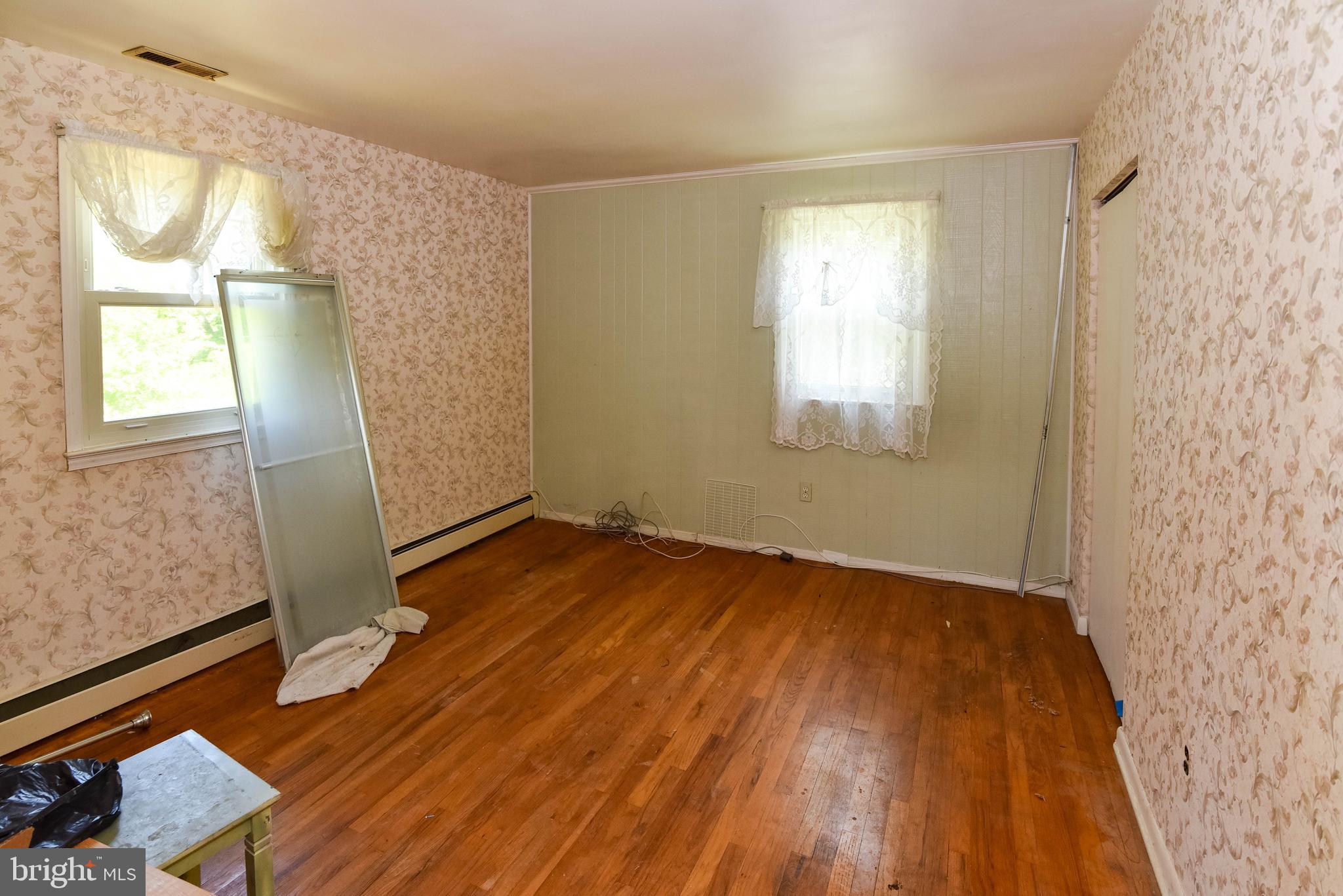 1204 Dicus Mill Road Millersville, MD 21108 - Photo 17 of 63 an empty room with wooden floor and windows