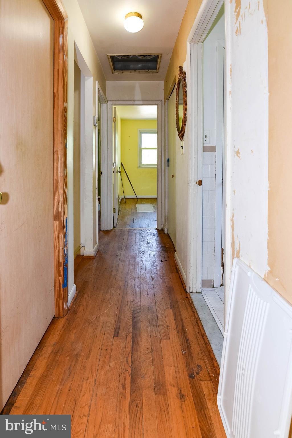 1204 Dicus Mill Road Millersville, MD 21108 - Photo 21 of 63 a view of a hallway with wooden floor and a bathroom