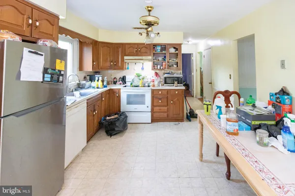 a kitchen with refrigerator and cabinets