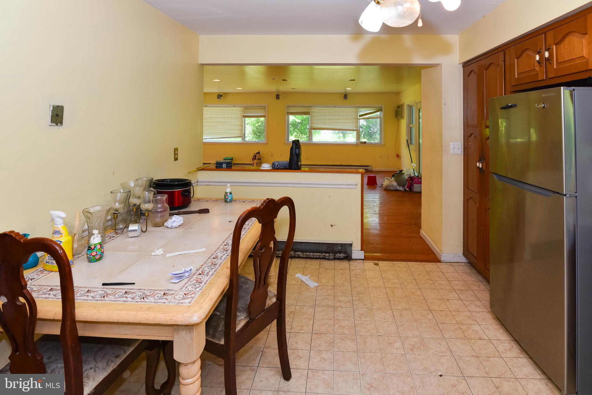 1204 Dicus Mill Road Millersville, MD 21108 - Photo 6 of 63 a dining room with furniture a window and kitchen view