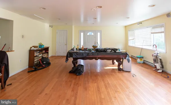 a view of a workspace with furniture and wooden floor