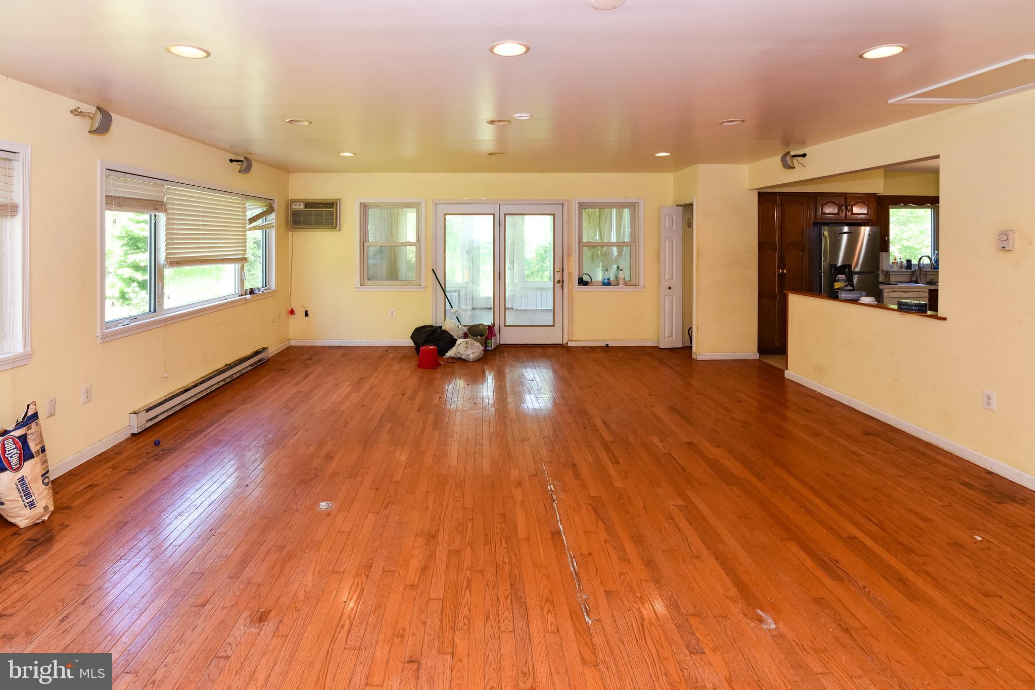 1204 Dicus Mill Road Millersville, MD 21108 - Photo 9 of 63 a view of an empty room with wooden floor and a window