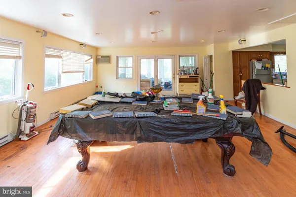 a living room with dining room and wooden floor