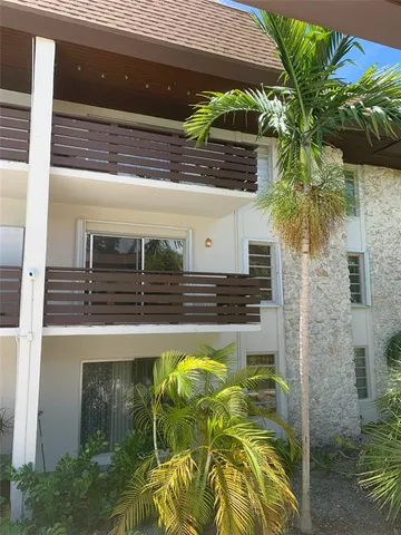 a view of swimming pool with table and chairs in front of house