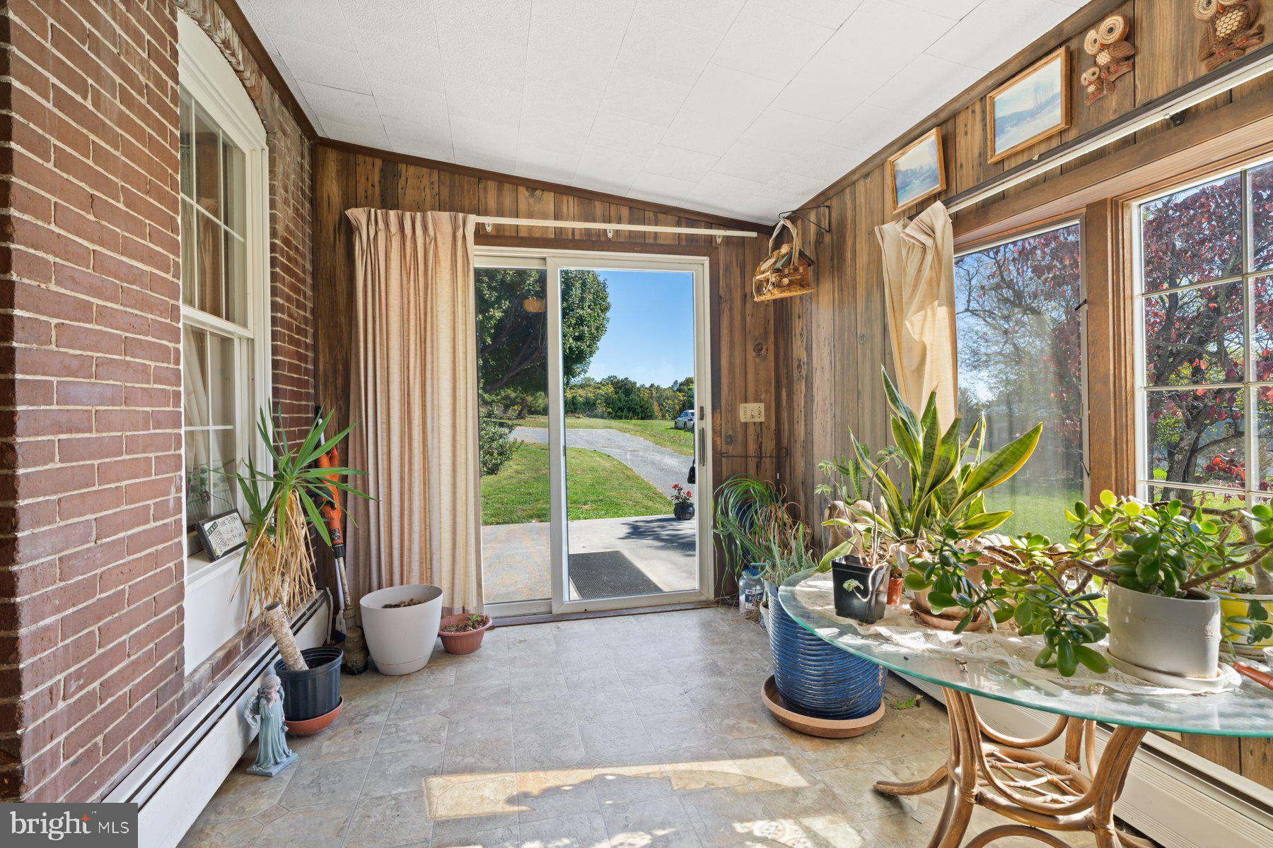 2943 Main Street Manchester, MD 21102 - Photo 16 of 43 a living room filled with furniture and a potted plant