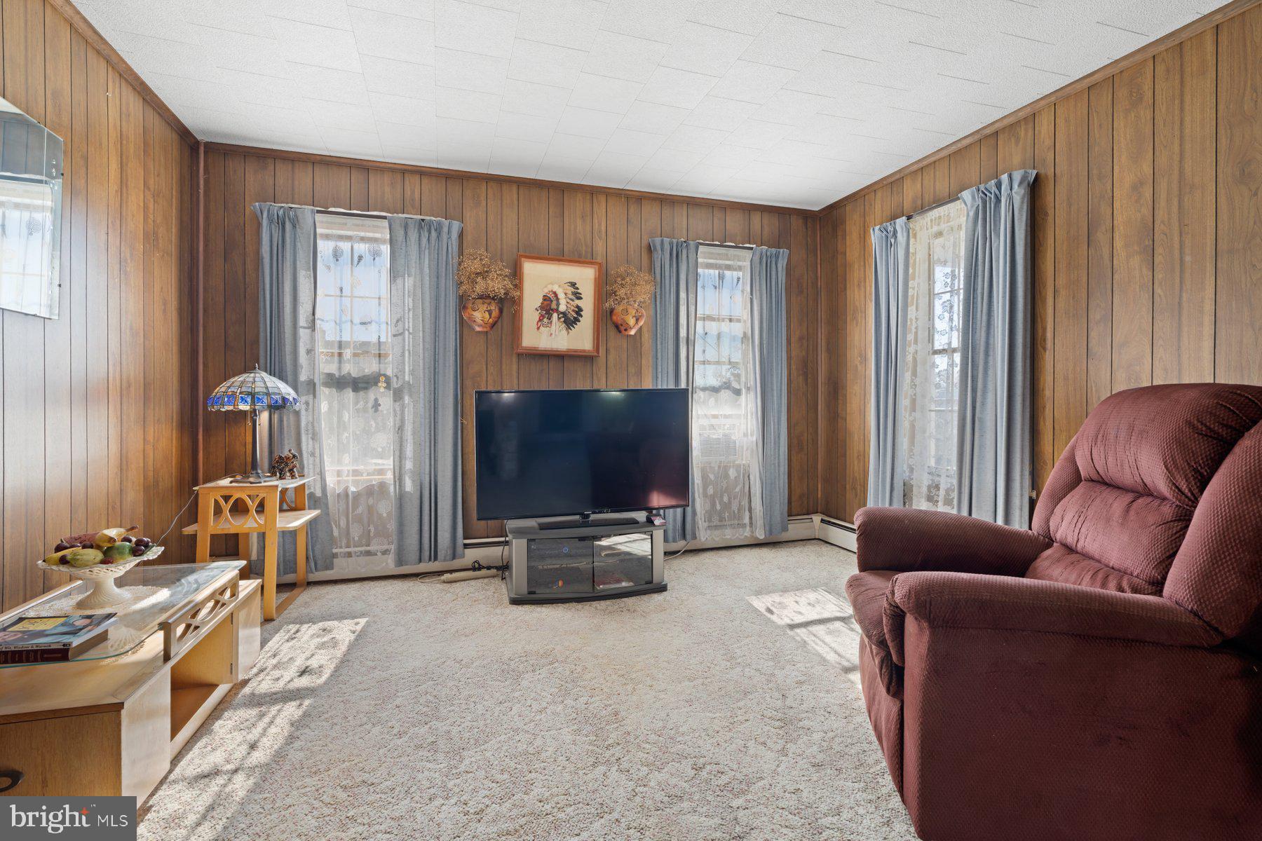 2943 Main Street Manchester, MD 21102 - Photo 23 of 43 a living room with furniture a large window and a flat screen tv