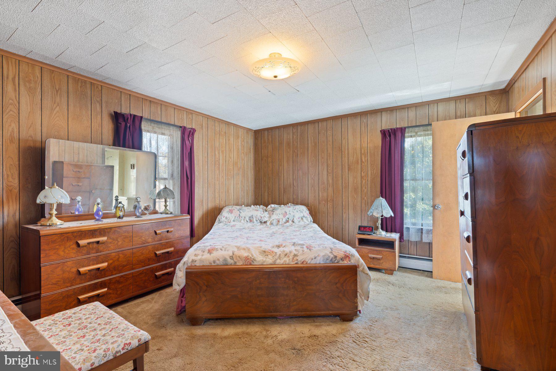 2943 Main Street Manchester, MD 21102 - Photo 33 of 43 a spacious bedroom with a bed and dresser with mirror