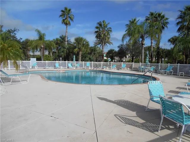 a view of a swimming pool with lounge chairs
