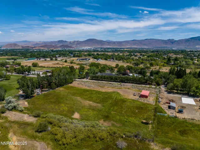 a view of a town with swimming pool and mountains