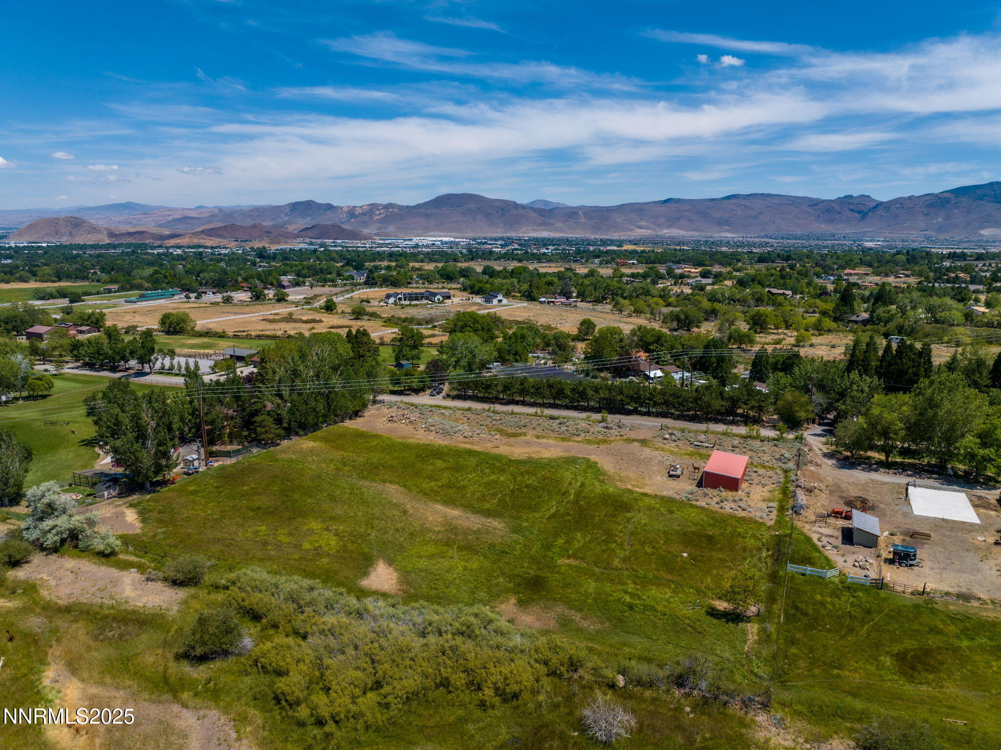 a view of a town with swimming pool and mountains
