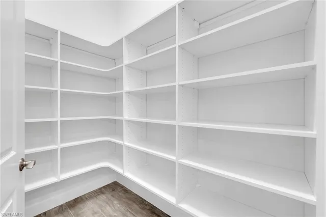 a view of walk in closet with empty racks