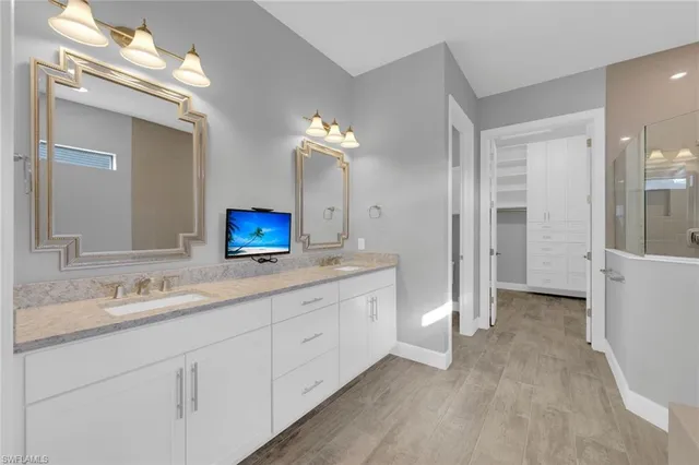 a bathroom with a double vanity sink and a mirror