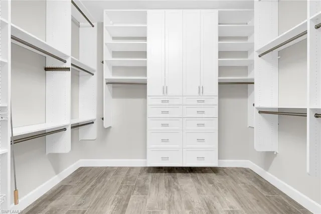 a view of walk in closet with empty racks