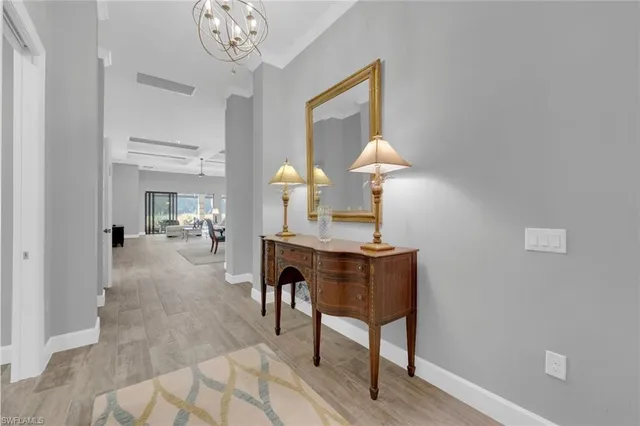 a view of a dining room with furniture and a chandelier