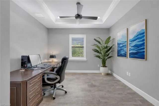 a view of a workspace with furniture and a window