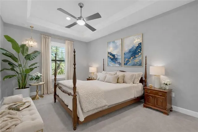 a bedroom with a large bed and a chandelier