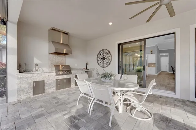 a view of a dining room with furniture and a kitchen