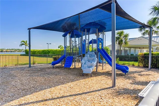 a view of a house with a yard and slide