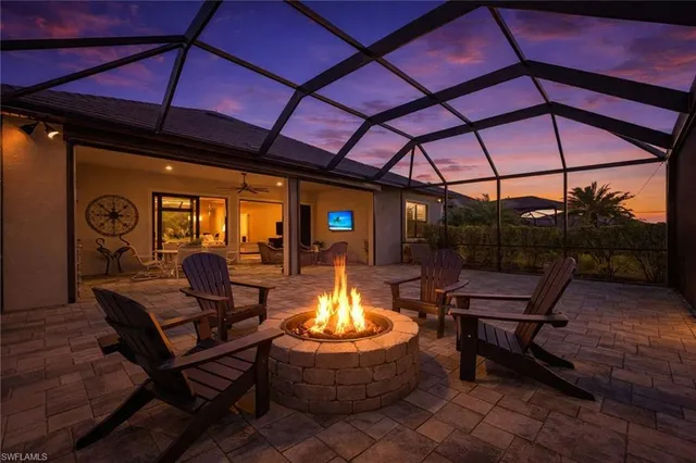 a outdoor living space with patio furniture and a fireplace
