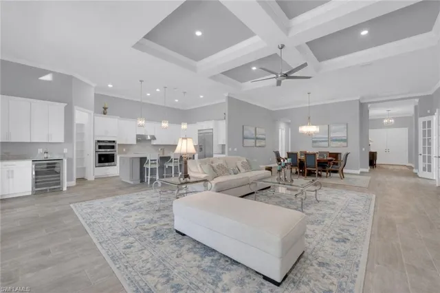 a living room with furniture fireplace and kitchen view