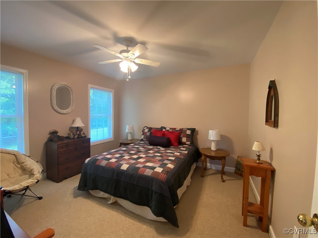 4554 Plank Road Kenbridge, VA 23944 - Photo 30 of 41 a bedroom with a bed and a chandelier