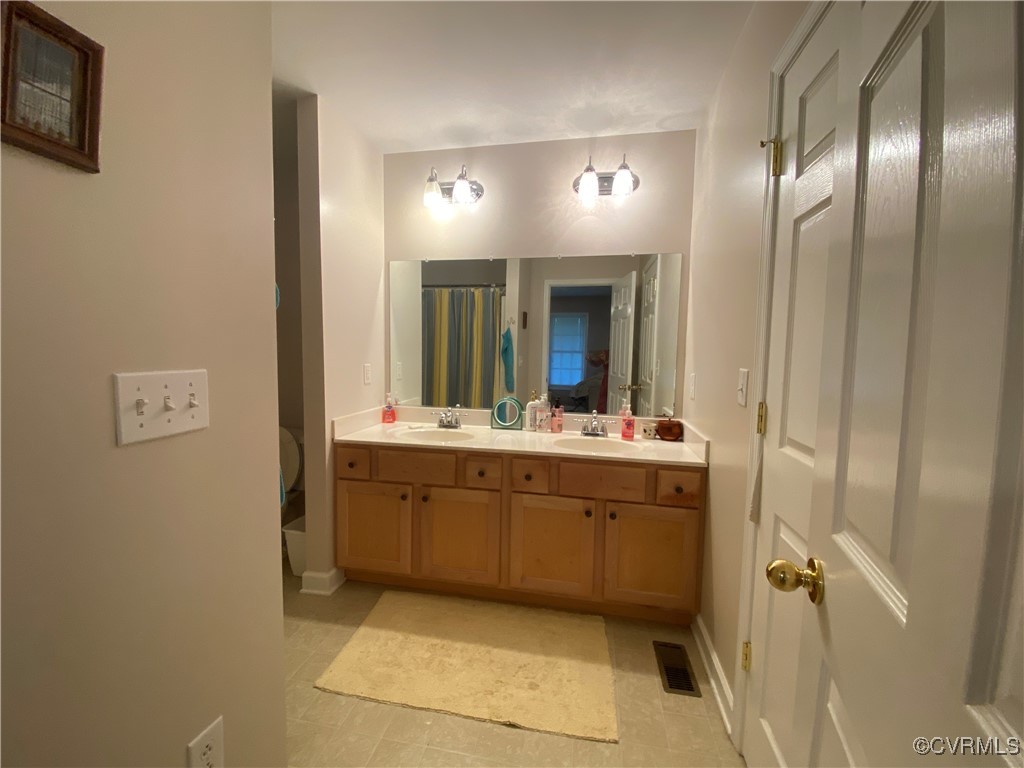 4554 Plank Road Kenbridge, VA 23944 - Photo 33 of 41 a bathroom with a double vanity sink and mirror