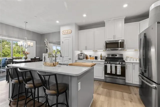 a view of a dining room with furniture and a flat screen tv