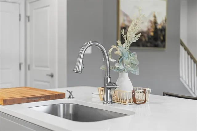 a vase of flowers sitting on a table with wooden floor