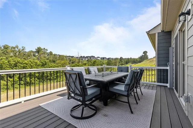 a roof deck with wooden floor and fence