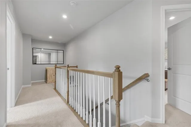a spacious bedroom with a large bed and a chandelier