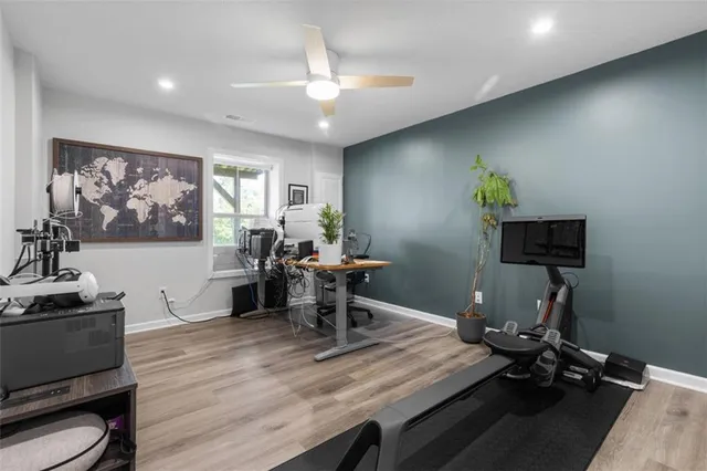 a view of a patio with table and chairs with wooden floor and fence