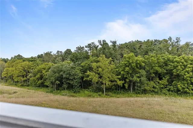 an aerial view of a house with a garden and lake view
