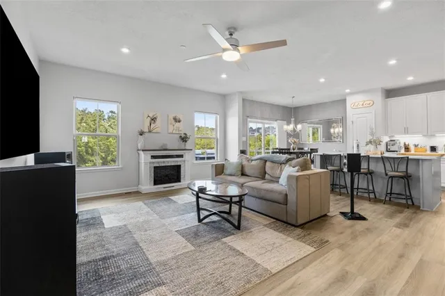 a living room with furniture and kitchen view