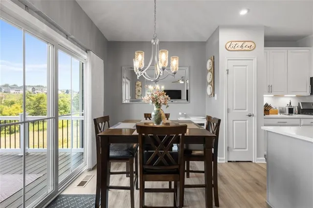 a kitchen with a table chairs refrigerator and cabinets