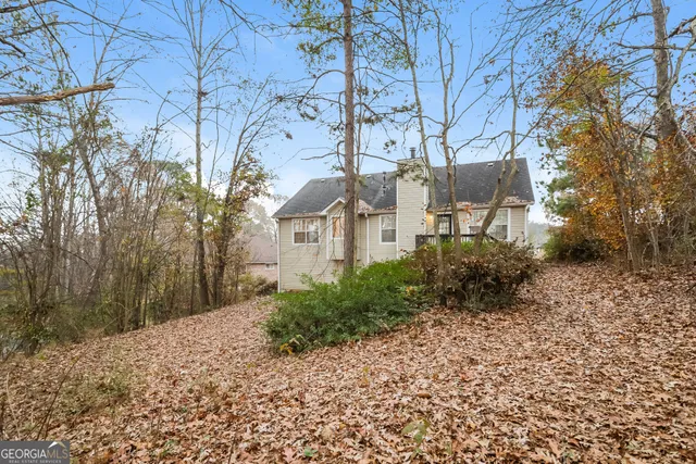 a view of a house with a yard covered with snow