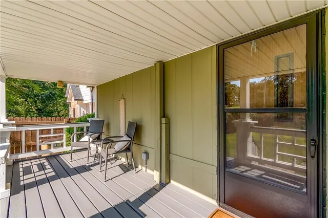 a balcony view with a large window and wooden floor
