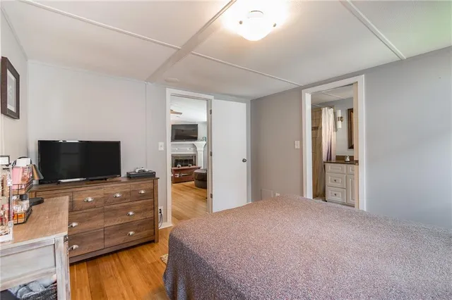 a bedroom with furniture and flat screen tv