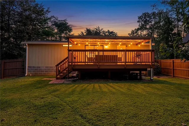 a view of a house with swimming pool and sitting area