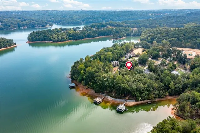 an aerial view of a house with a yard and lake view