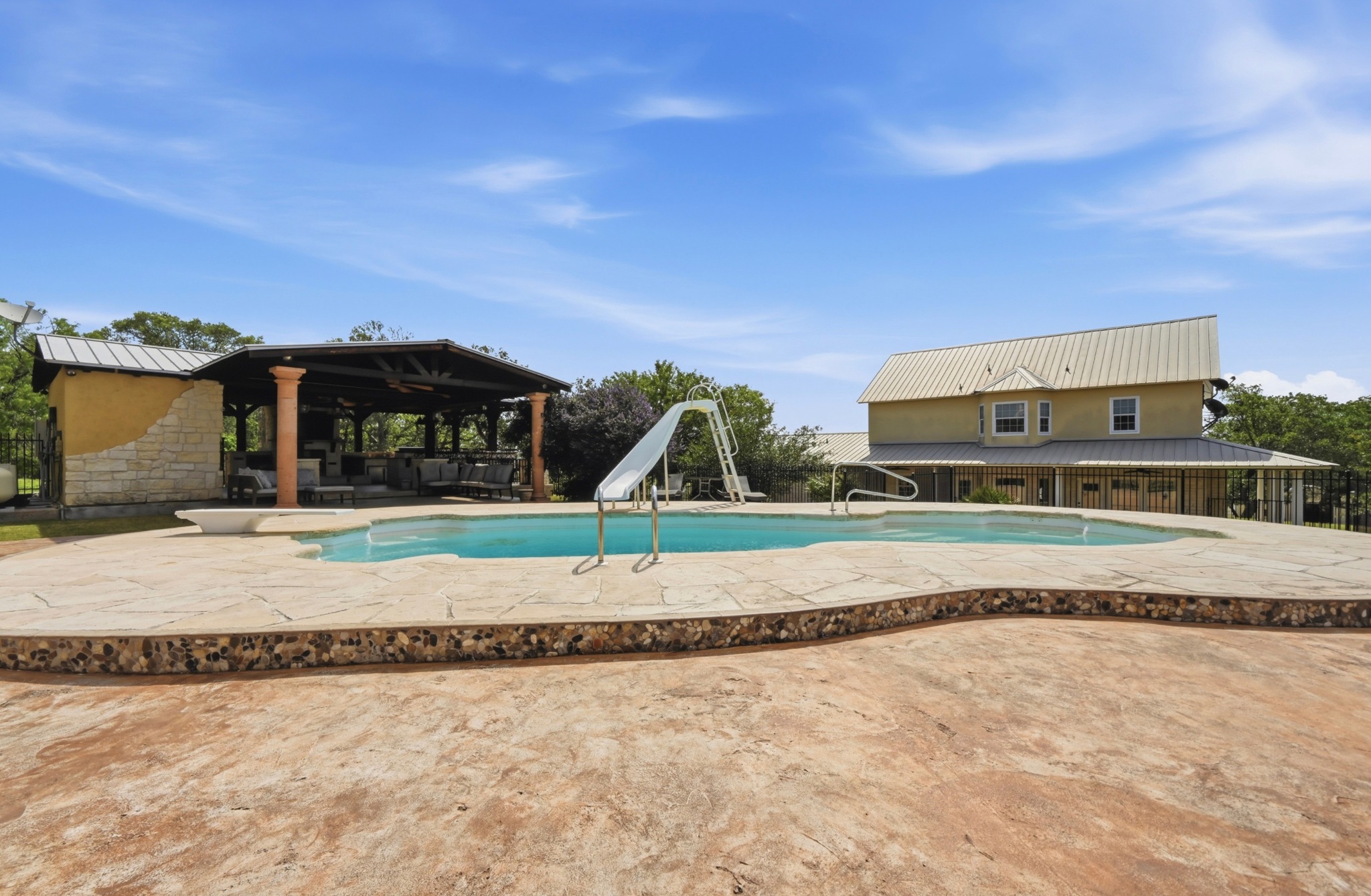 1175 Southern Way Luling, TX 78648 - Photo 35 of 40 An inviting in-ground pool with a slide creates a refreshing outdoor oasis.