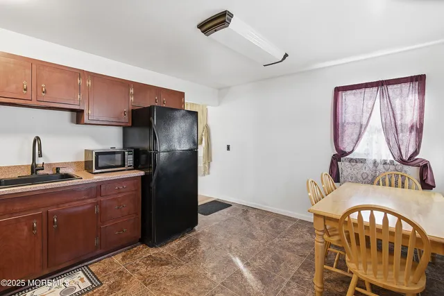 a kitchen with stainless steel appliances granite countertop a refrigerator a stove a sink and dishwasher