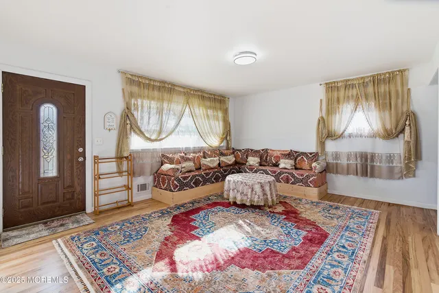 a bedroom with furniture and a wooden floor