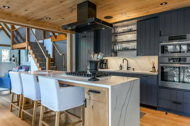 a kitchen with a table chairs stove and cabinets