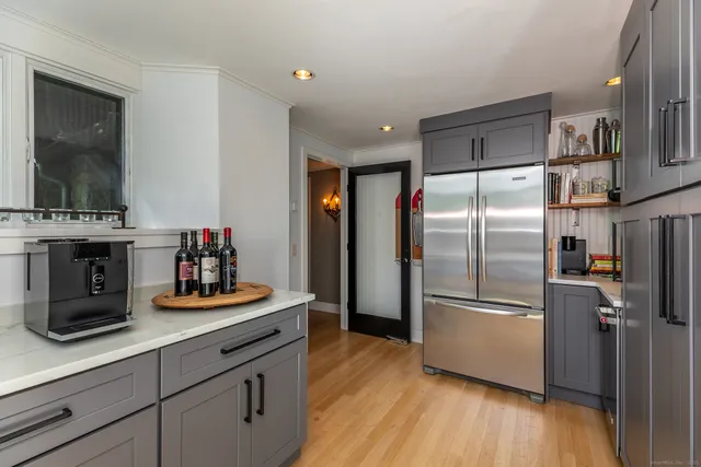 a kitchen with refrigerator and cabinets