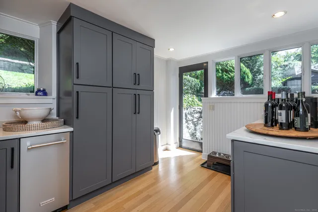 a kitchen with sink cabinets and wooden floor