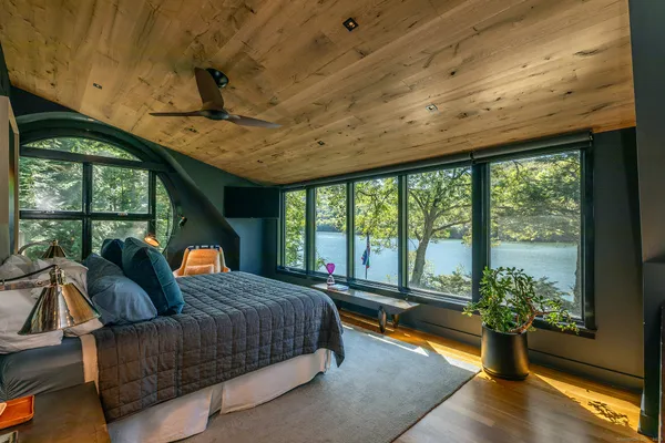 a bedroom with furniture and large windows