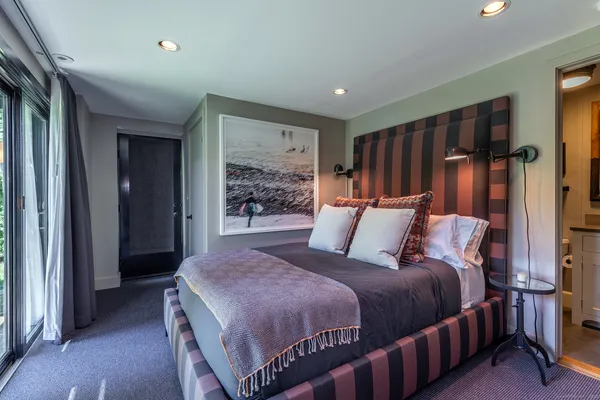 a bedroom with bed and window