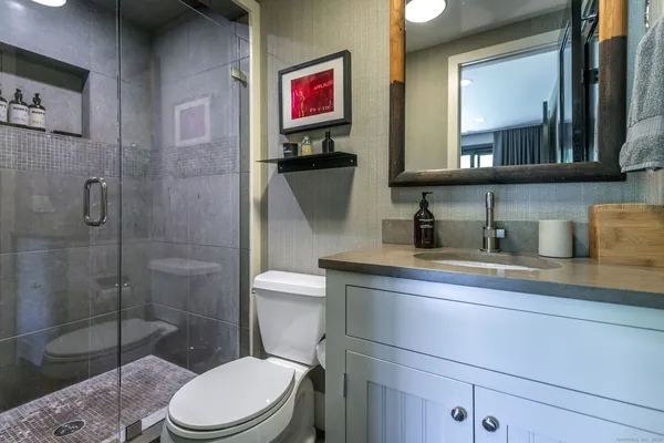 a bathroom with a toilet sink and shower
